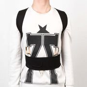 Person wearing an adjustable posture corrector for back support