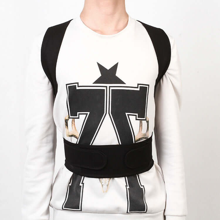 Person wearing an adjustable posture corrector for back support