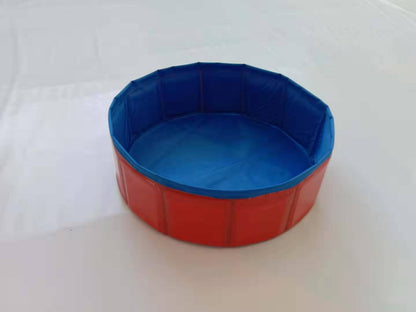 Foldable dog pool set up outdoors with a golden retriever inside