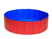 Foldable dog pool set up outdoors with a golden retriever inside