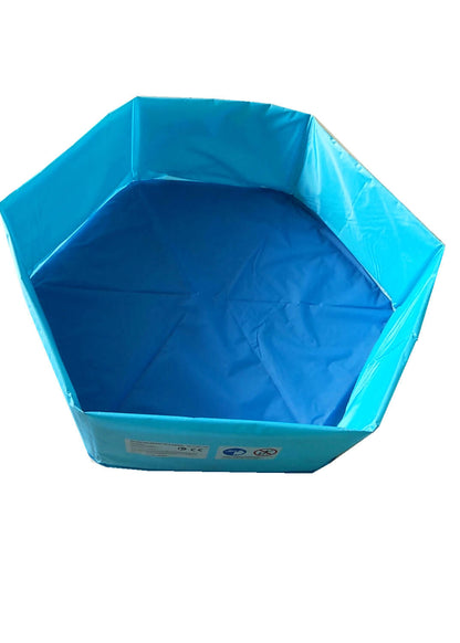 Foldable dog pool set up outdoors with a golden retriever inside